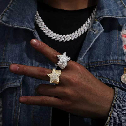 Two star rings, one gold-tone and one silver-tone, with pavé stones on adjacent fingers