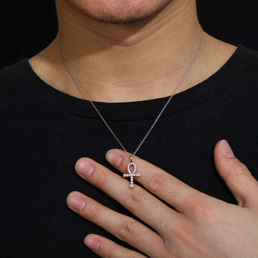 Silver-tone ankh pendant with clear stones worn on a fine chain over a black shirt