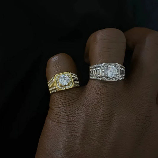 Two rings, one gold-tone and one silver-tone, with stone-covered rectangular faces on adjacent fingers