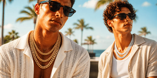 Two stylish male models wearing gold and silver miami cuban link chain necklaces in a sunny outdoor IceGrind hip hop jewelry shoot.