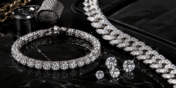 IceGrind moissanite tennis bracelet and iced-out moissanite chain on black marble, highlighting high-quality moissanite fire, stone clarity, and premium hip hop jewelry craftsmanship.