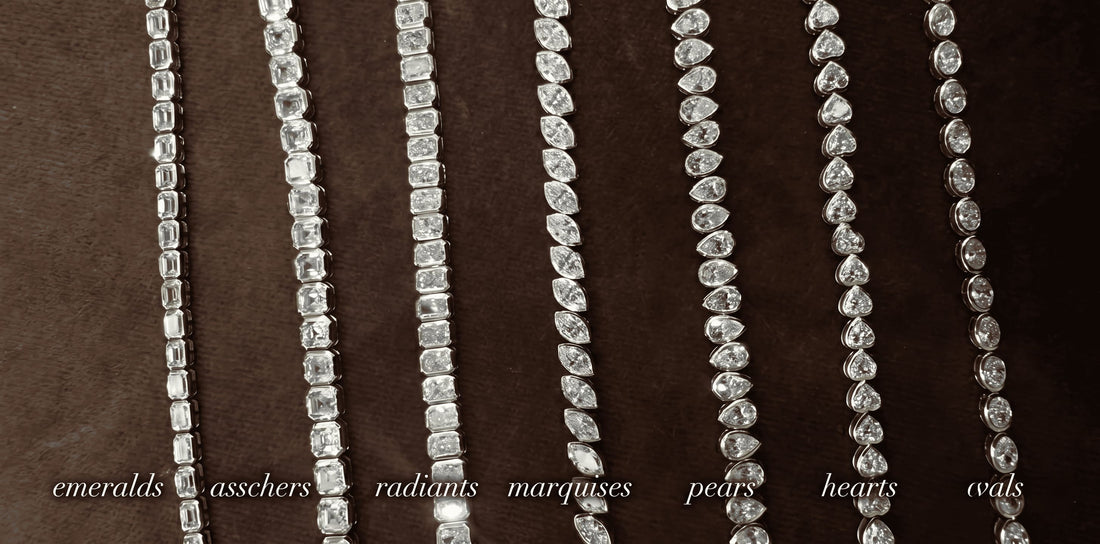 Macro photo of seven distinct diamond tennis chains with bezel settings showcasing different cuts—emeralds, asschers, radiants, marquises, pears, hearts, and ovals—laid out and labeled on dark velvet. An iced-out showcase by icegrind.