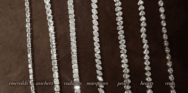 Macro photo of seven distinct diamond tennis chains with bezel settings showcasing different cuts—emeralds, asschers, radiants, marquises, pears, hearts, and ovals—laid out and labeled on dark velvet. An iced-out showcase by icegrind.