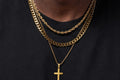 IceGrind gold chain collection featuring layered gold chains and a cross pendant on a Black male model