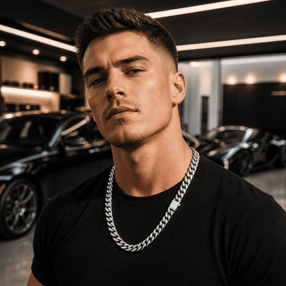 Professional portrait of a man wearing the IceGrind 12MM cuban link miami chain in a modern showroom, highlighting it as a versatile and powerful statement piece.