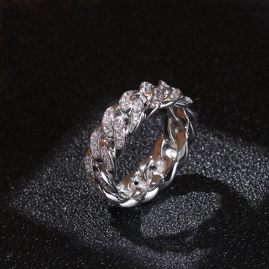Silver-tone Cuban link ring with clear stones in an angled view on black fabric