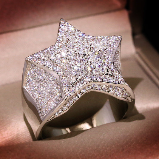 Silver-tone star ring with full stone coverage, lying flat on light-colored fabric