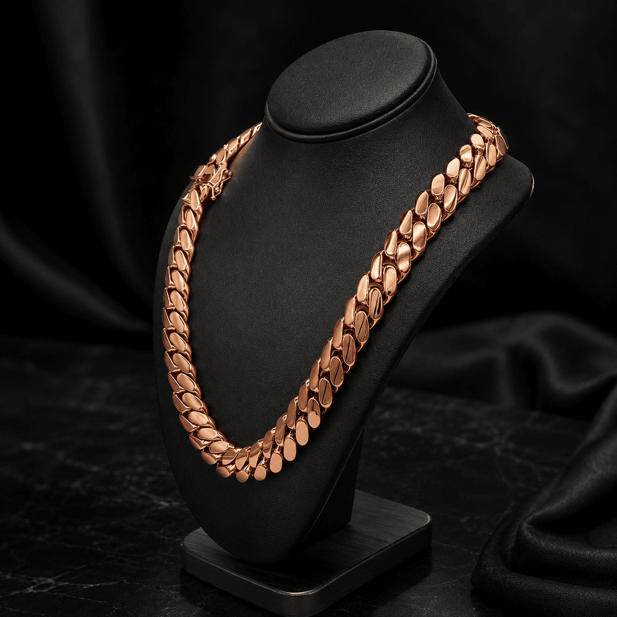 16MM rose gold Miami Cuban link chain draped over a black display bust with its box clasp visible