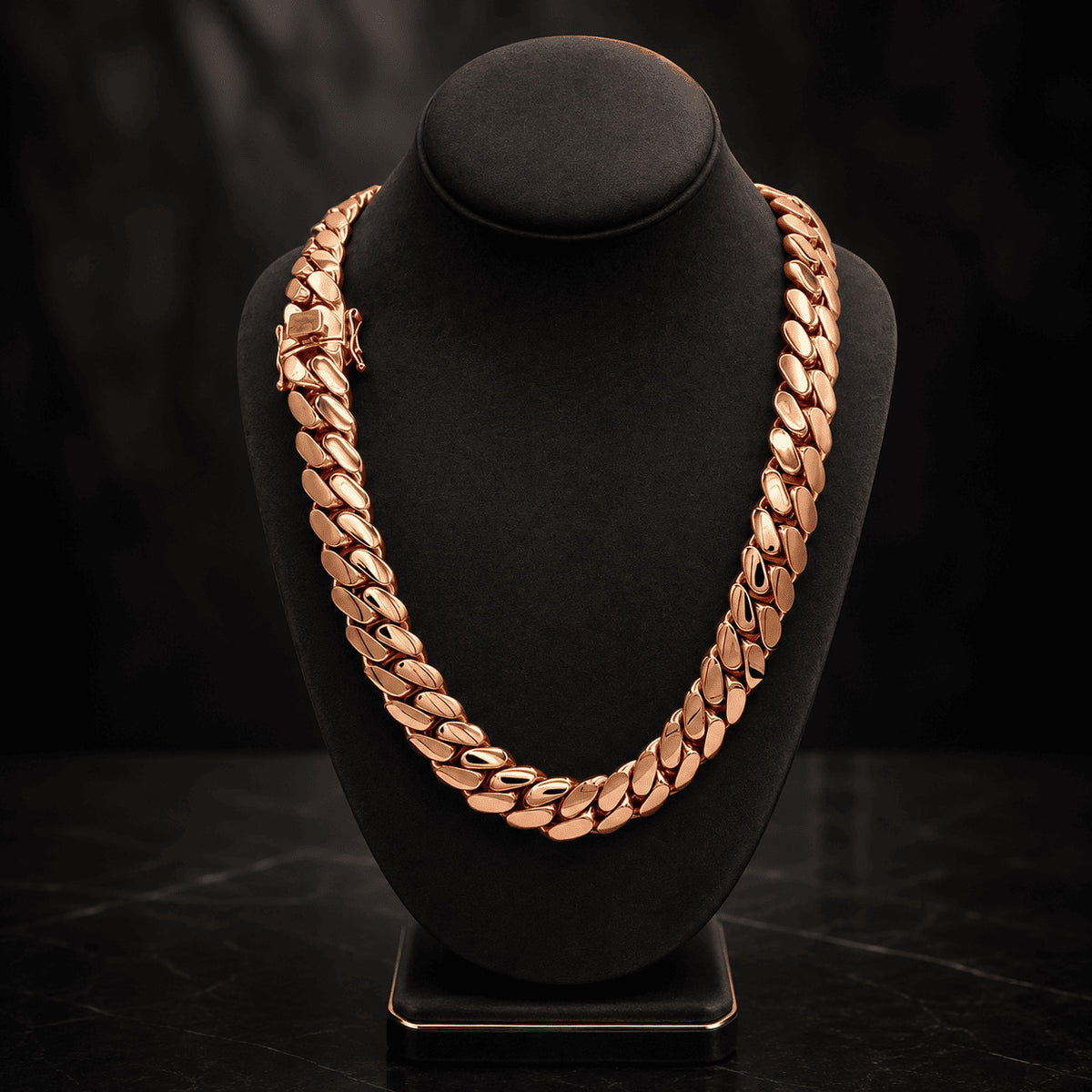 16MM rose gold Miami Cuban link chain draped over a black display bust on a dark surface with its box clasp visible