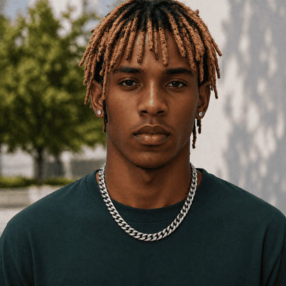 10MM white gold Miami Cuban link chain worn around the neck on a model for fit and style in a blurred outdoor setting