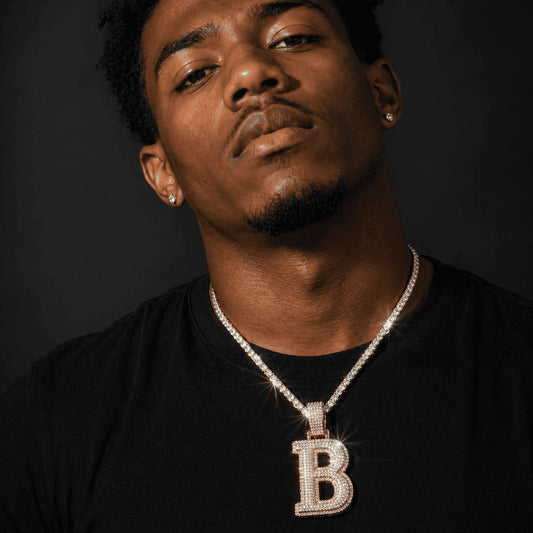 Close up of a model wearing the IceGrind silver initial pendant necklace. A fully iced-out custom B initial pendant.