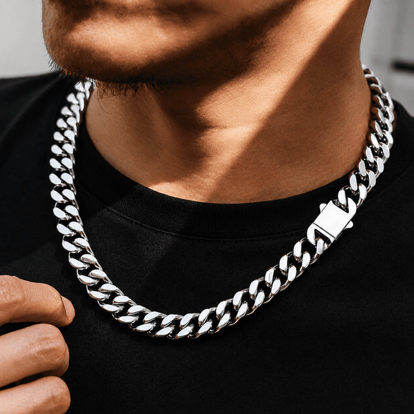 Detailed view of the IceGrind 12MM cuban link miami chain showcased on a man’s neck, emphasizing its heavy, premium construction and brilliant metallic shine.
