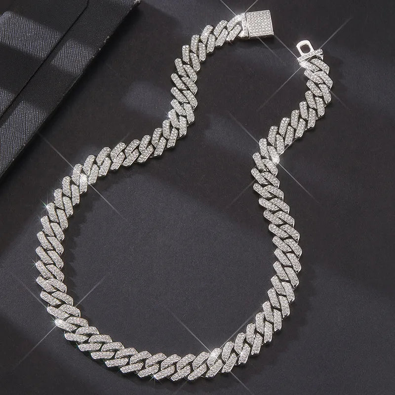 Curved looped 14MM white gold Cuban link chain displayed on dark textured fabric
