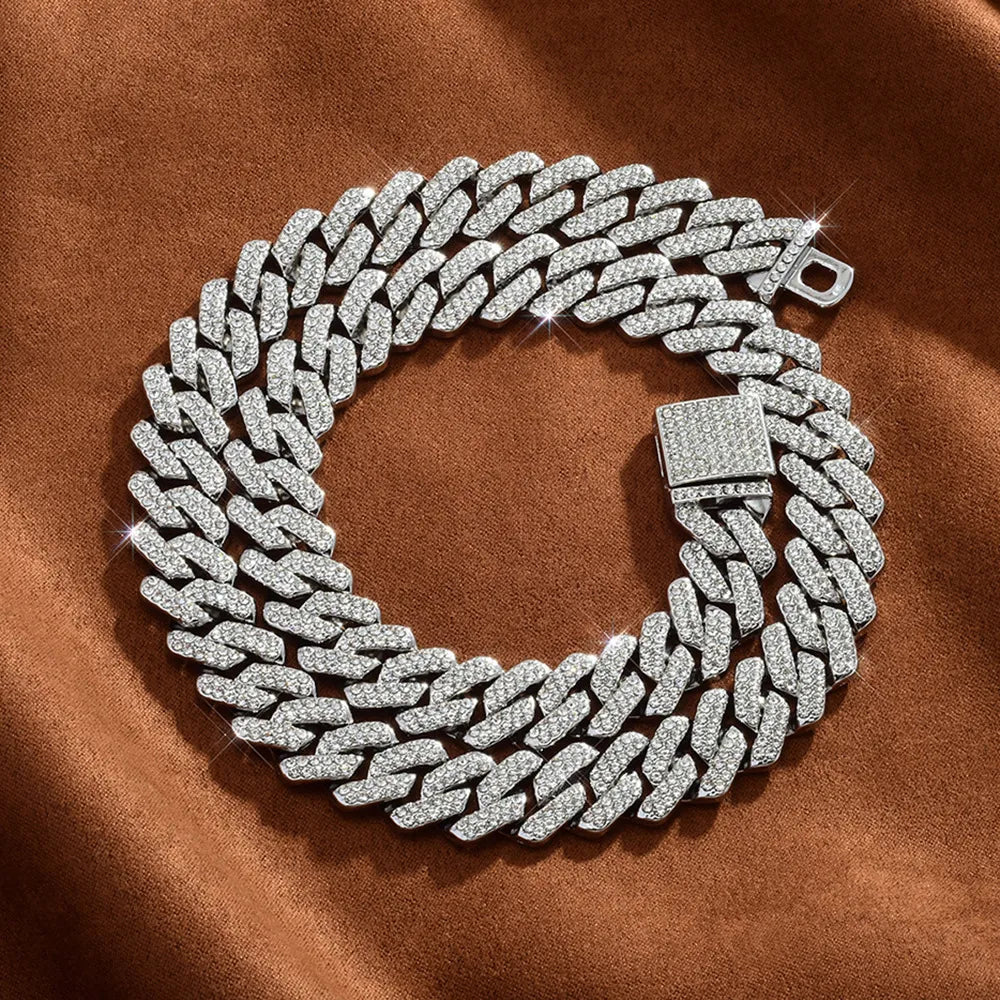 Coiled 14MM white gold Cuban link chain with its box clasp visible