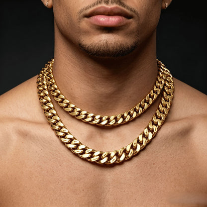 Layered 12MM 18k gold cross Cuban link chain worn around the neck against a dark background