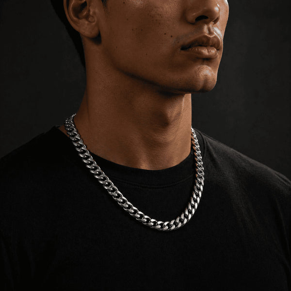 12MM white gold Miami Cuban link chain worn around the neck on a model for fit and style on a dark textured surface