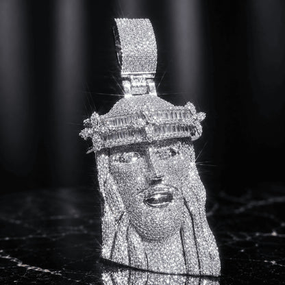 Brilliant silver-tone titanium steel Iced Out Baguette Crown Jesus Piece resting on a sleek black marble background.