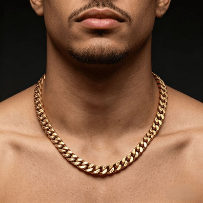 12MM 18k gold cross Cuban link chain worn around the neck against a dark background