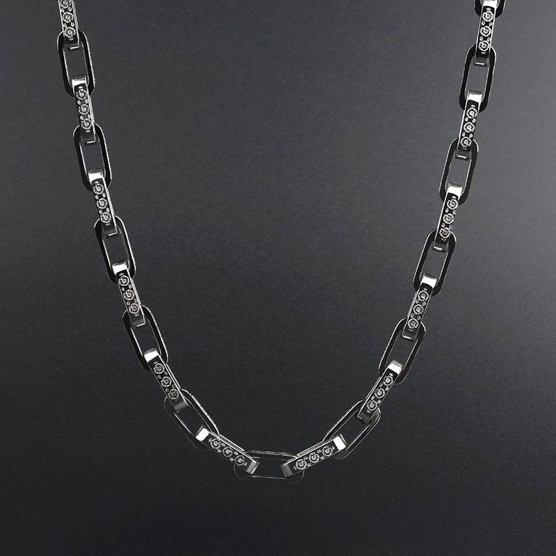 Curved white gold chain displayed against a dark gradient background