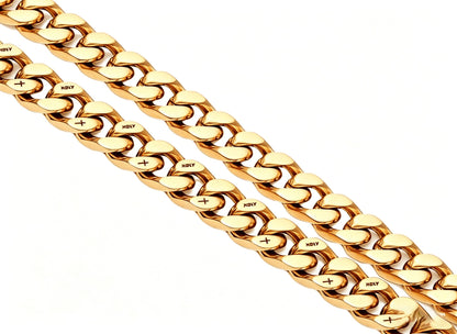 Coiled 12MM 18k gold cross Cuban link chain against a white background showing its wide link structure with its box clasp
