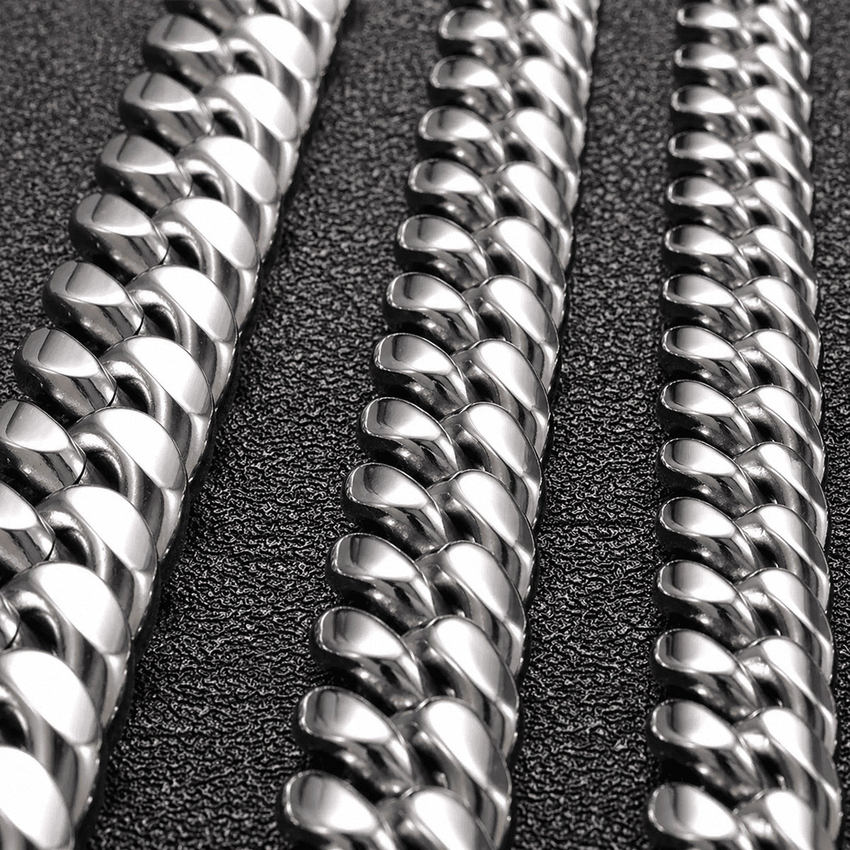 Three 6MM white gold Miami Cuban link chains shown in a parallel layout on a dark textured surface