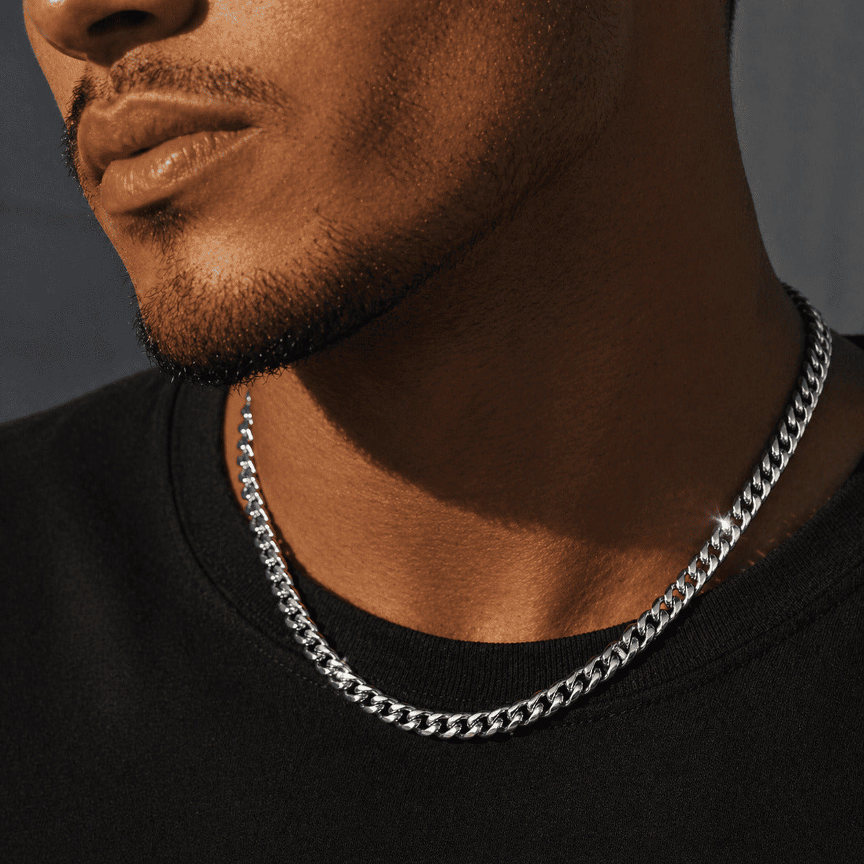 6mm White Gold Miami Cuban Link Chain by icegrind worn over a black shirt. Enhance your look with this cuban link miami chain.