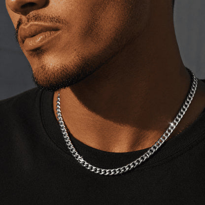 6mm White Gold Miami Cuban Link Chain by icegrind worn over a black shirt. Enhance your look with this cuban link miami chain.