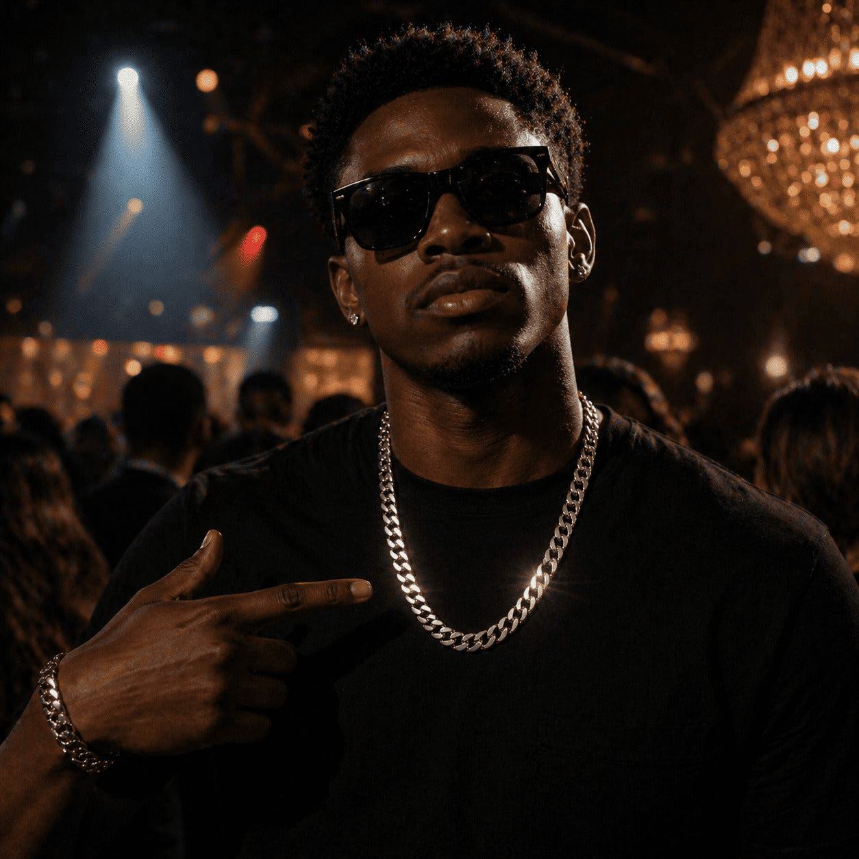 Model pointing at the showstopping IceGrind 12mm White Gold Miami Cuban Link Chain. The ultimate night-out hip-hop cuban link miami chain.