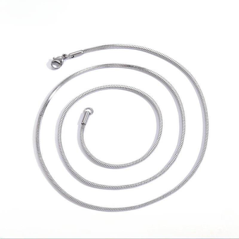 Coiled 2MM white gold snake chain against a white background with its lobster clasp visible