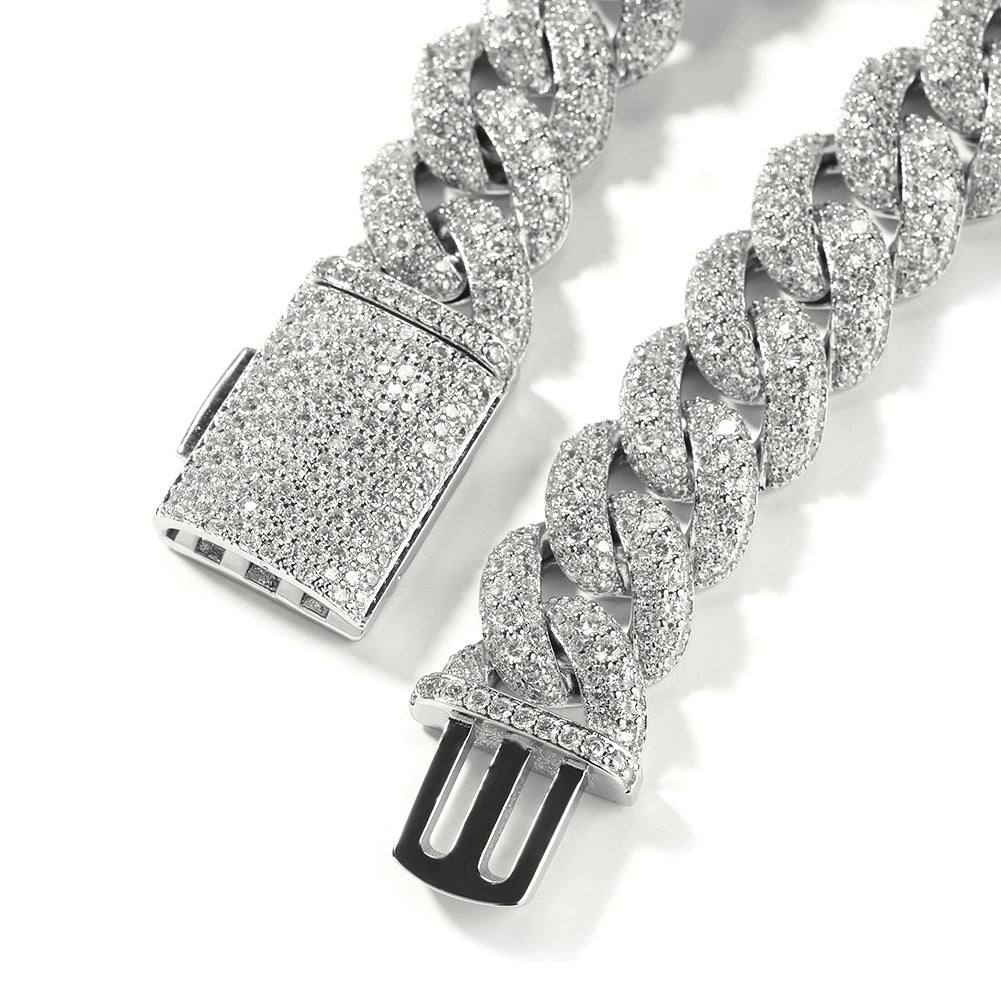 Coiled Miami Cuban link chain against a white background showing clasp detail with its box clasp visible