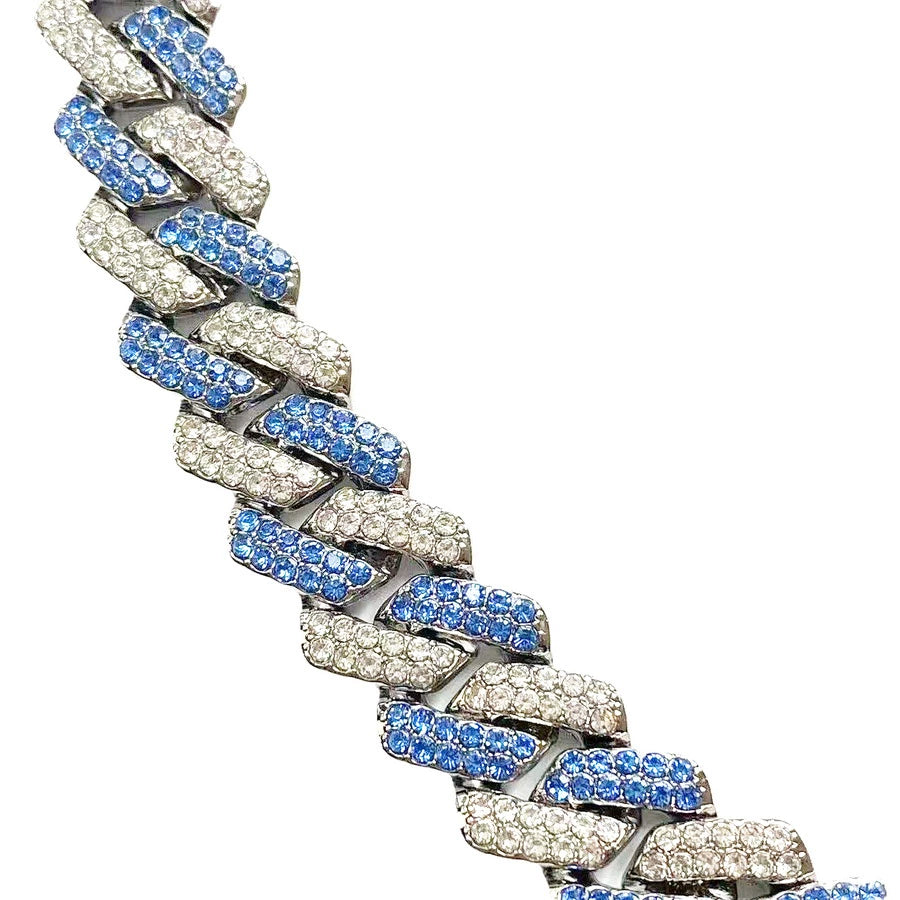 Close-up of 13MM white gold Cuban link chain links laid flat against a white background