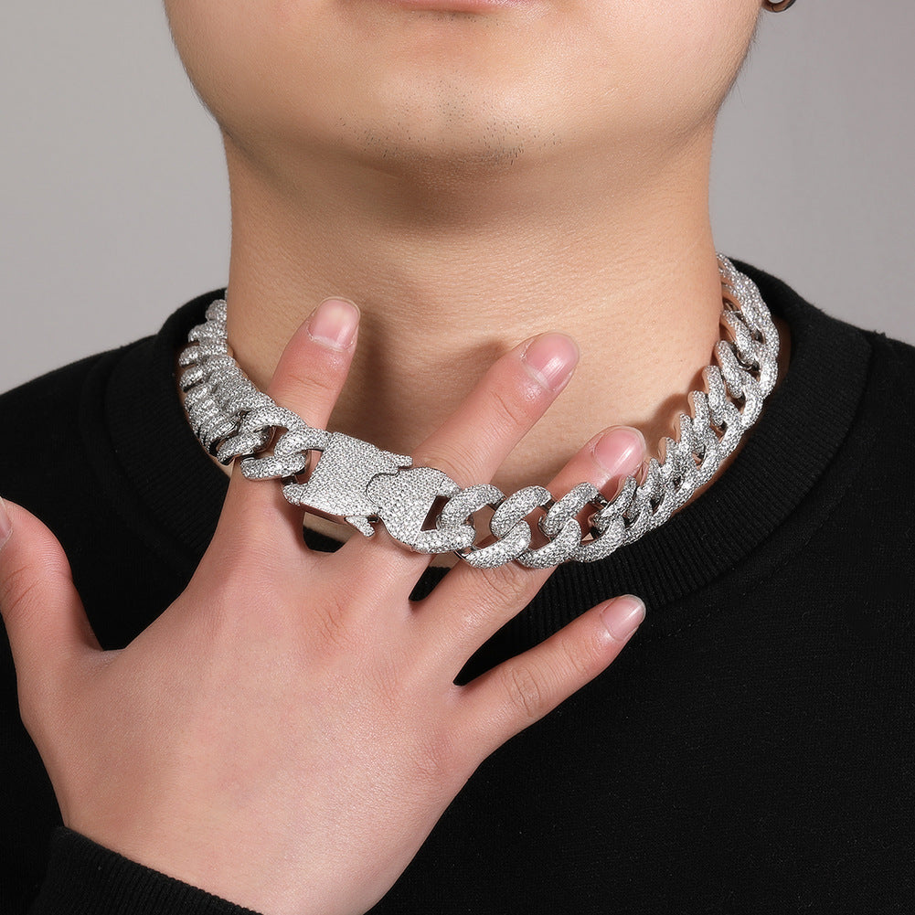 20MM white gold Cuban link chain worn around the neck against a neutral background