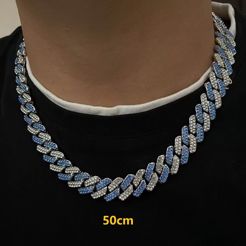 13MM white gold Cuban link chain worn around the neck on a model for fit and style over a black shirt with a white collar