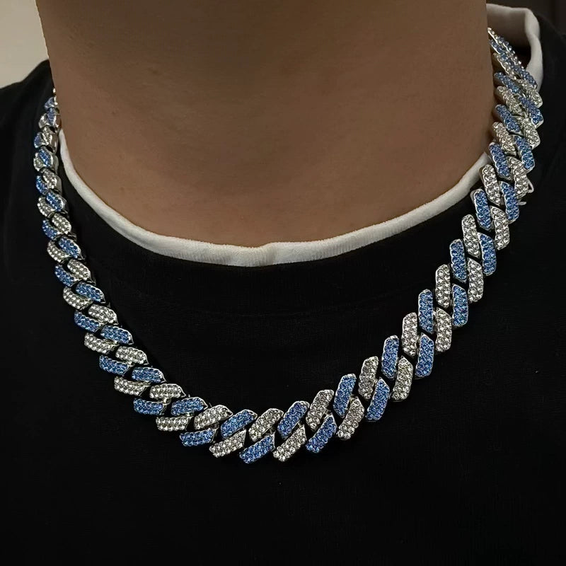 13MM white gold Cuban link chain worn around the neck with blue and white stone-encrusted links visible