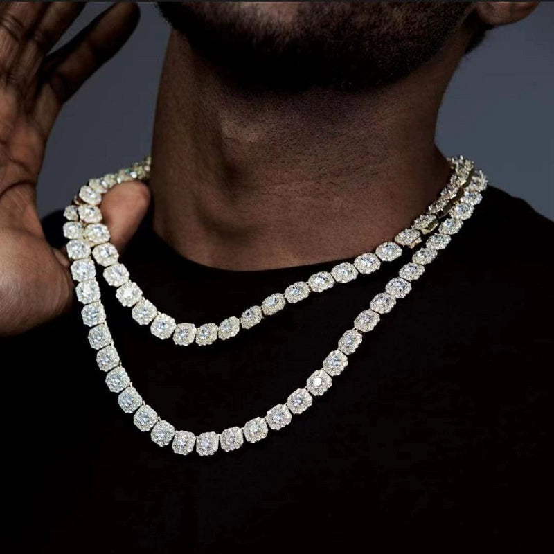 Layered 10MM gold tennis chain worn around the neck against a dark background