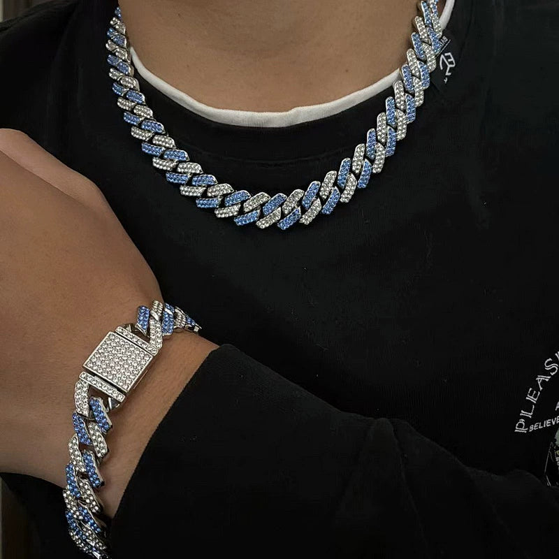 13MM white gold Cuban link chain worn around the neck with a matching bracelet visible on the wrist