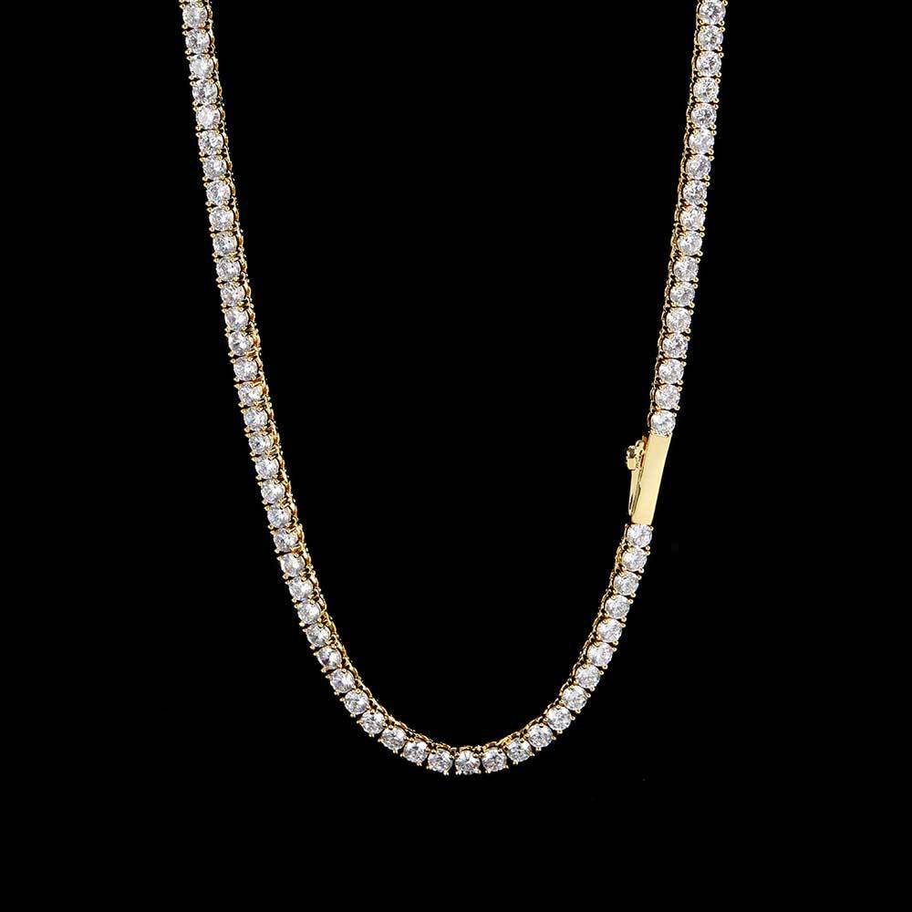 gold tennis chain displayed on a textured black surface