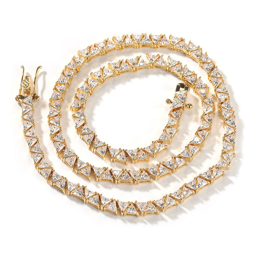 Coiled 5MM gold pyramid tennis chain against a white background with its clasp visible