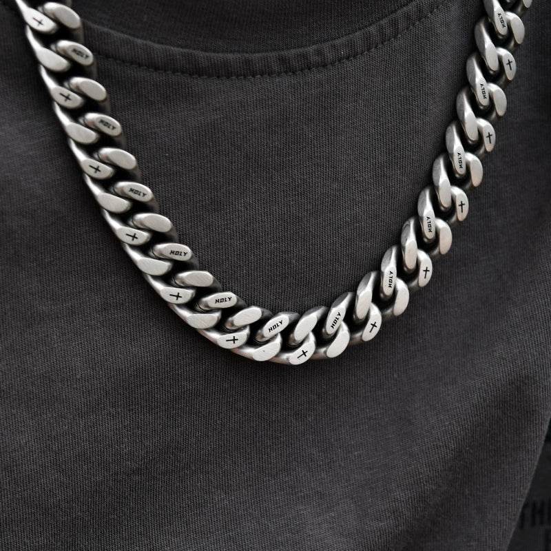 white gold Miami Cuban link chain worn around the neck on a model for fit and style