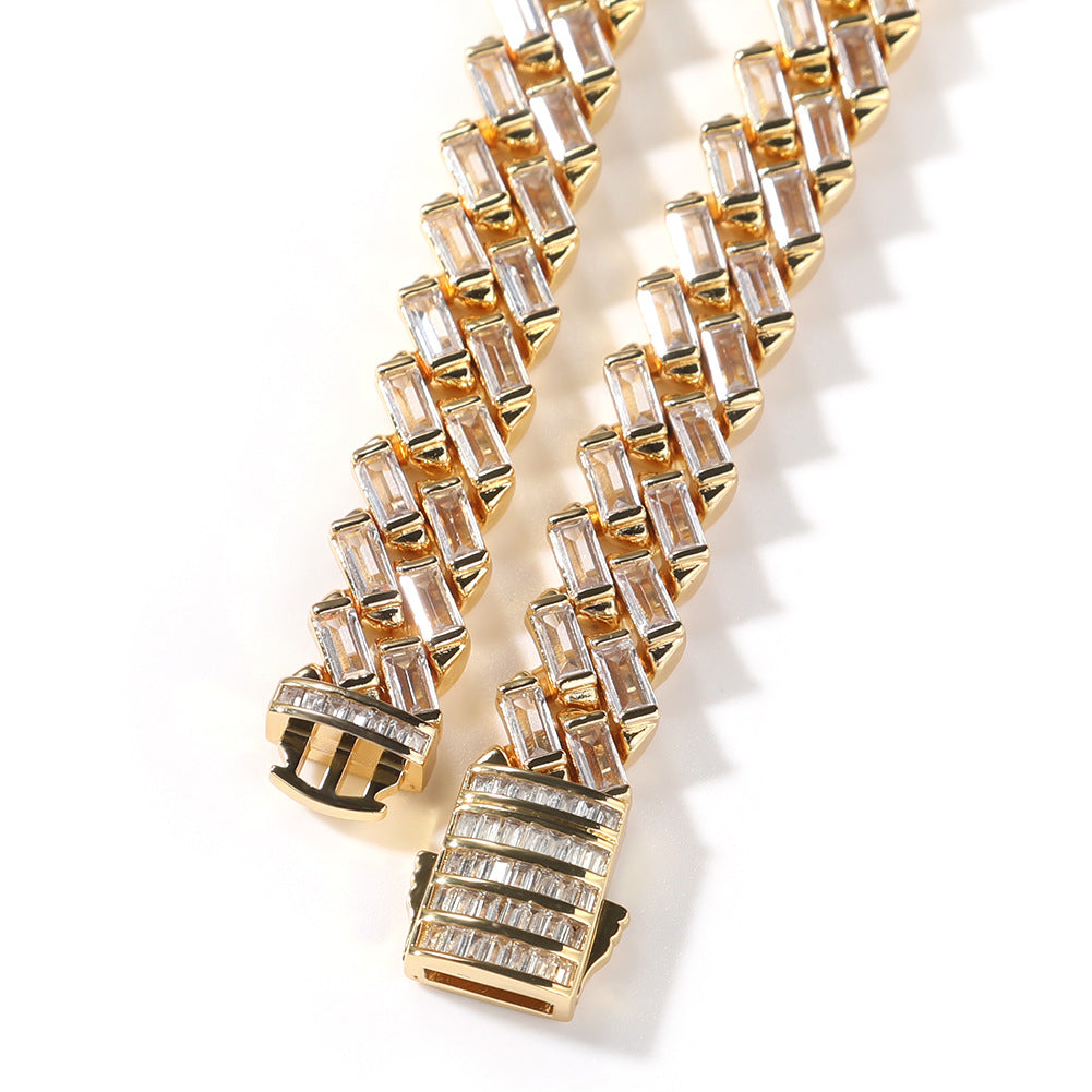 Close-up of Miami Cuban link chain links and box clasp laid flat against a white background