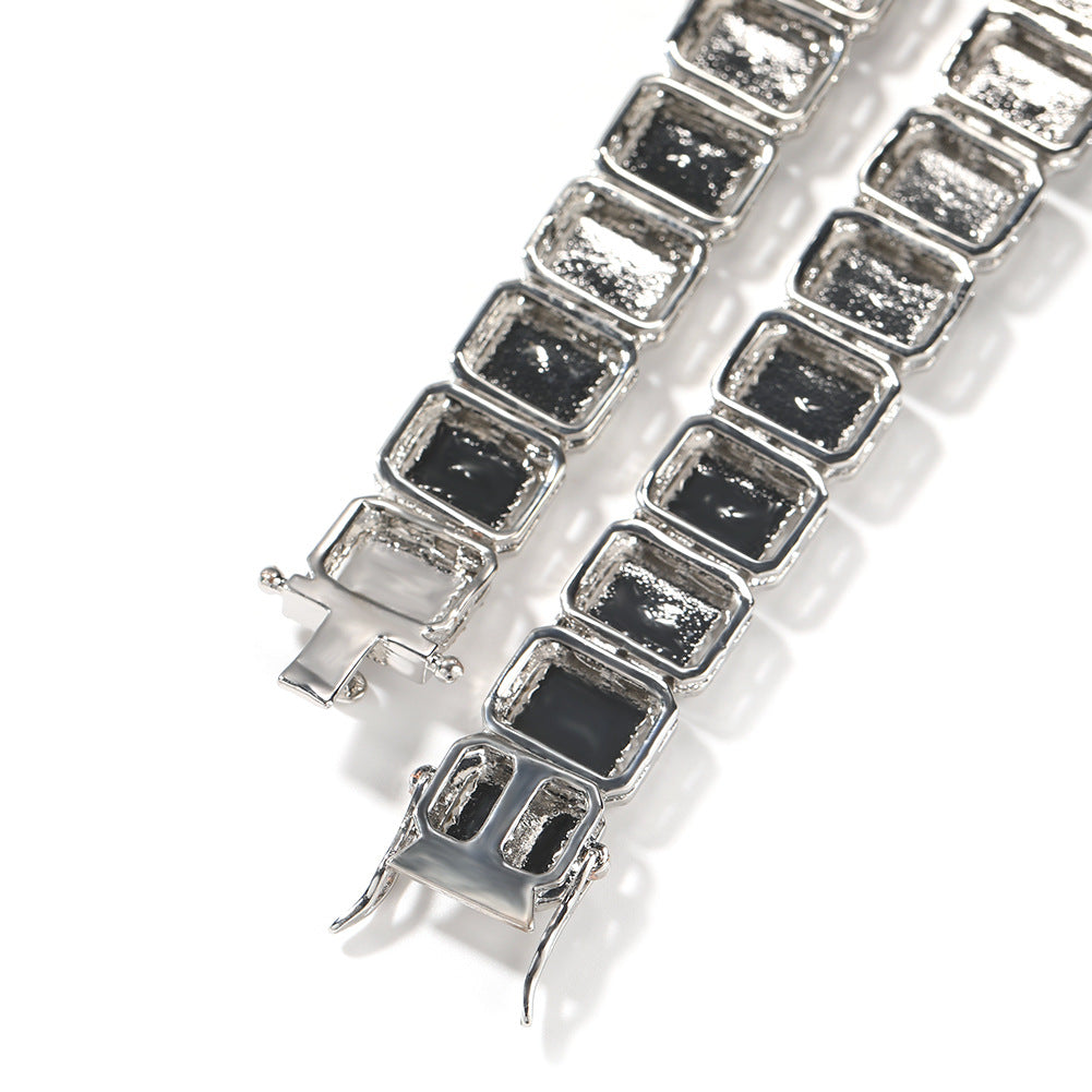 Coiled 13MM white gold tennis chain against a white background with its clasp visible