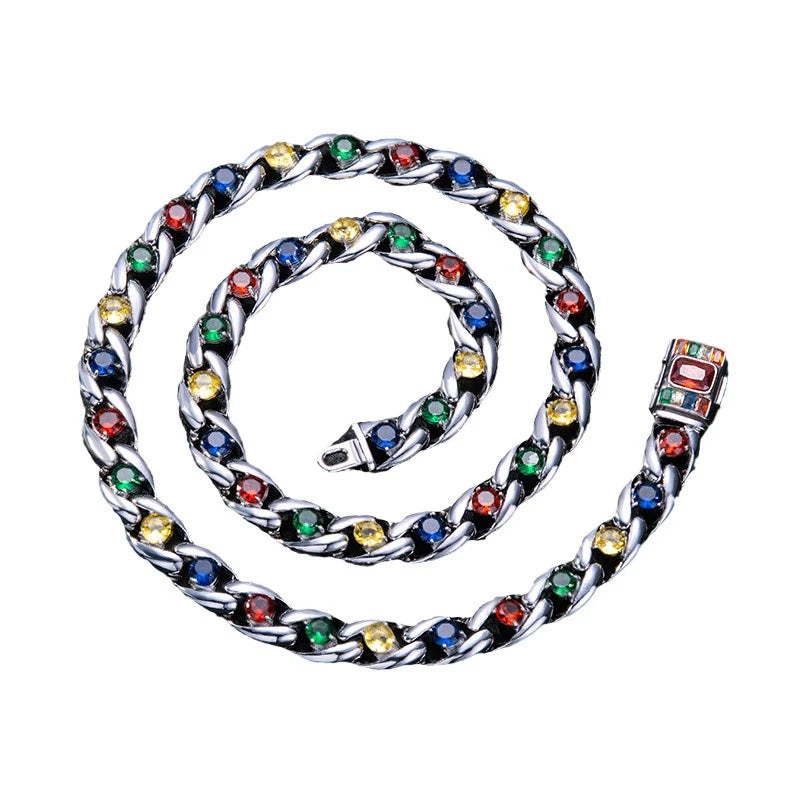 Coiled 10MM white gold Cuban link chain against a white background with its box clasp visible