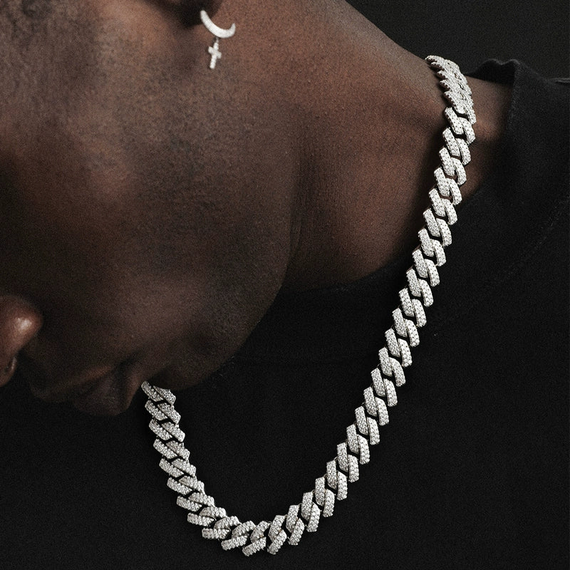 14MM white gold Cuban link chain worn around the neck against a dark background
