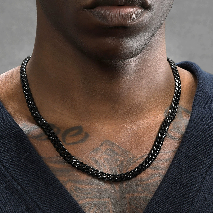 8MM black Cuban link chain worn around the neck against a neutral background