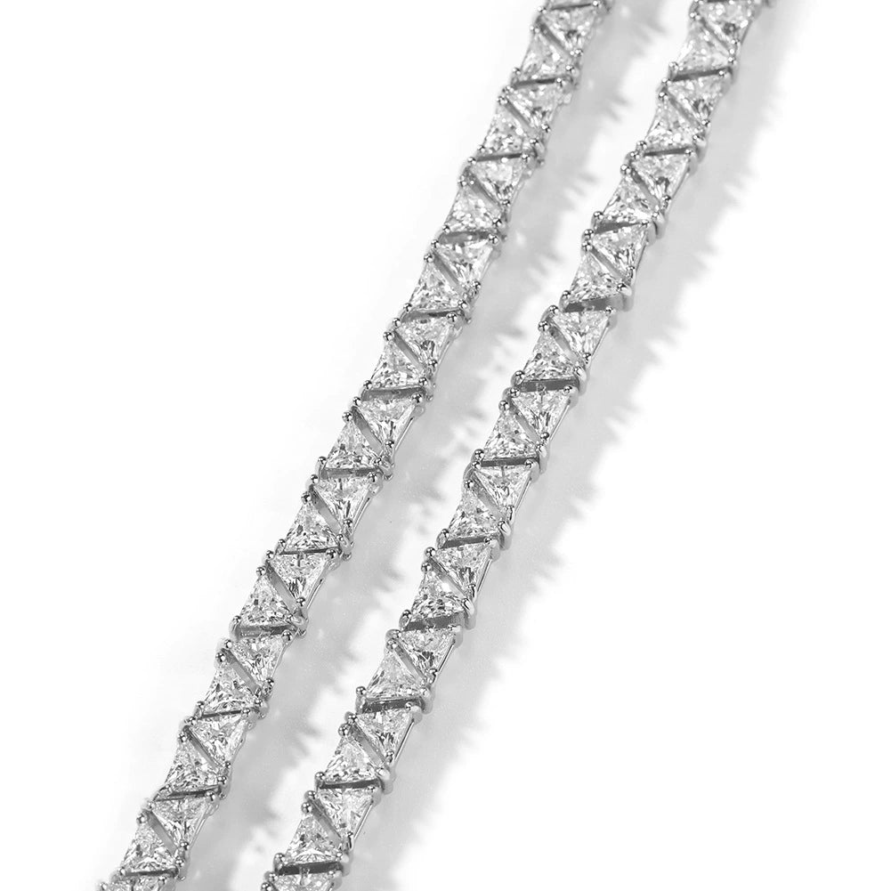 Close-up of 5MM white gold pyramid tennis chain links laid flat against a white background