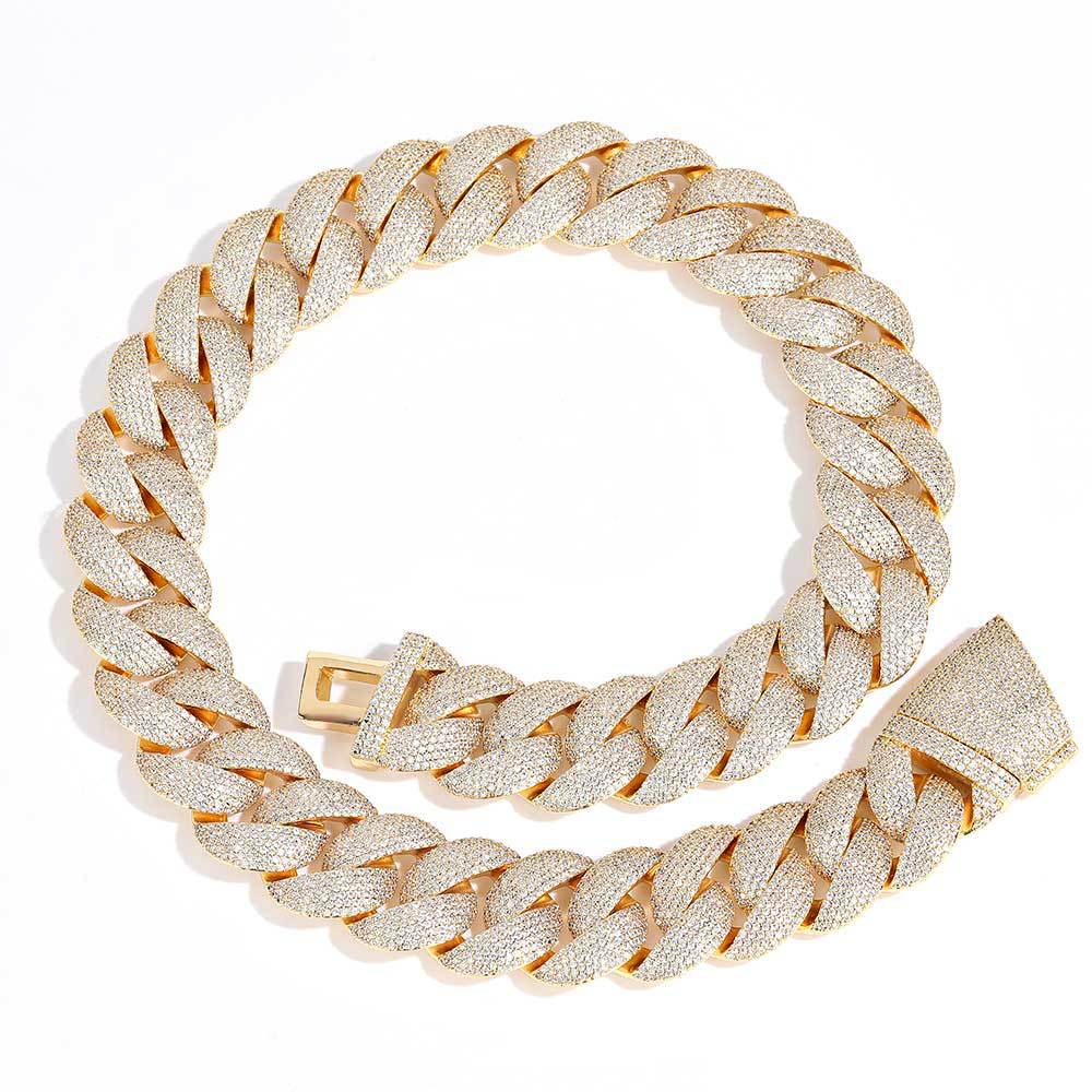 Coiled 24MM gold Cuban link chain against a white background with its box clasp visible