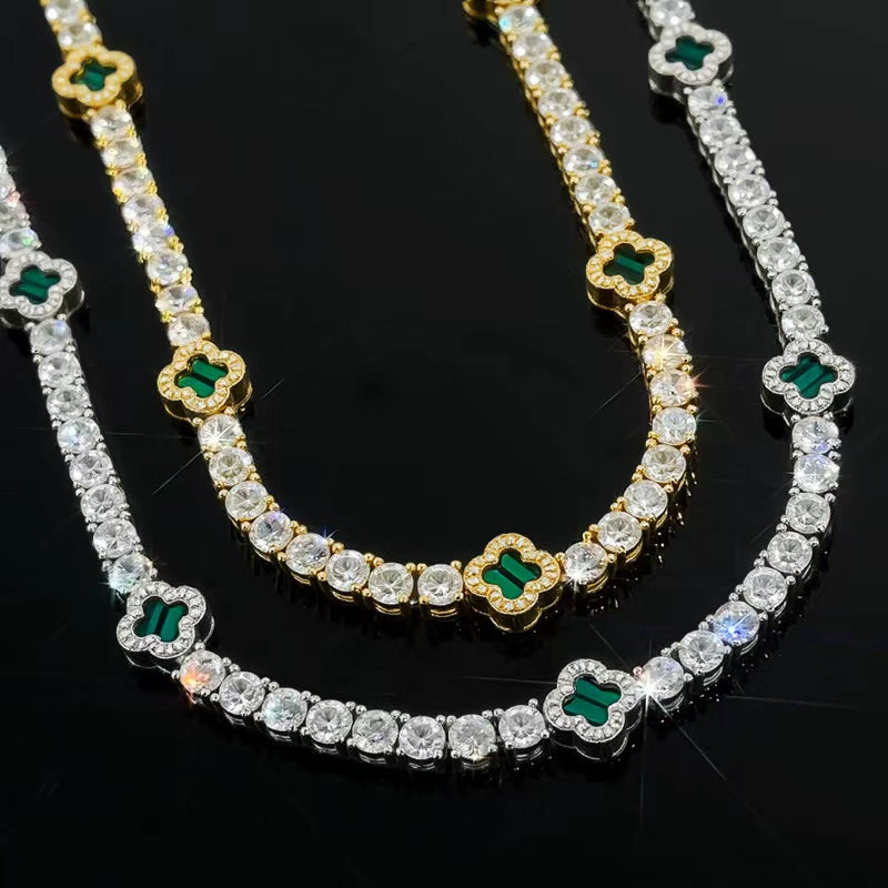 Three tennis chains placed side by side on a dark reflective surface