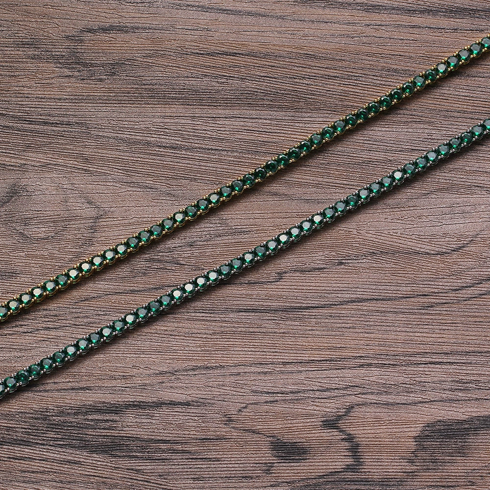 Two tennis chains overlapping in parallel on a wooden surface