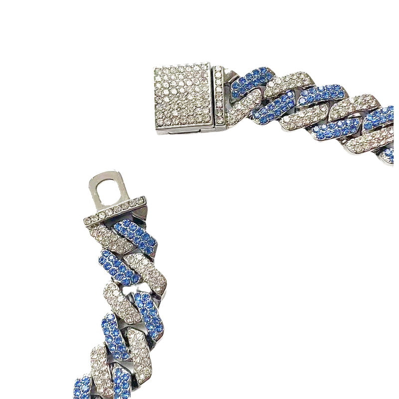 Curved 13MM white gold Cuban link chain displayed on black fabric