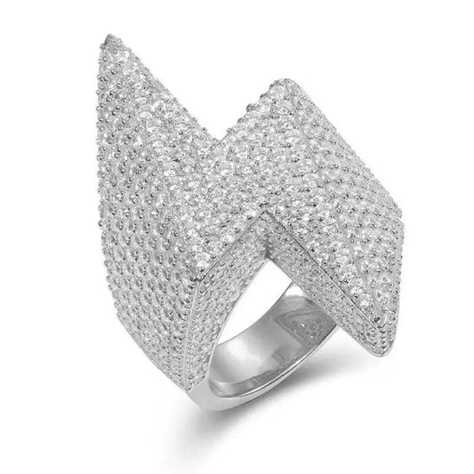 Silver-tone sculpted ring with an angular stone-covered top in a close-up angled view